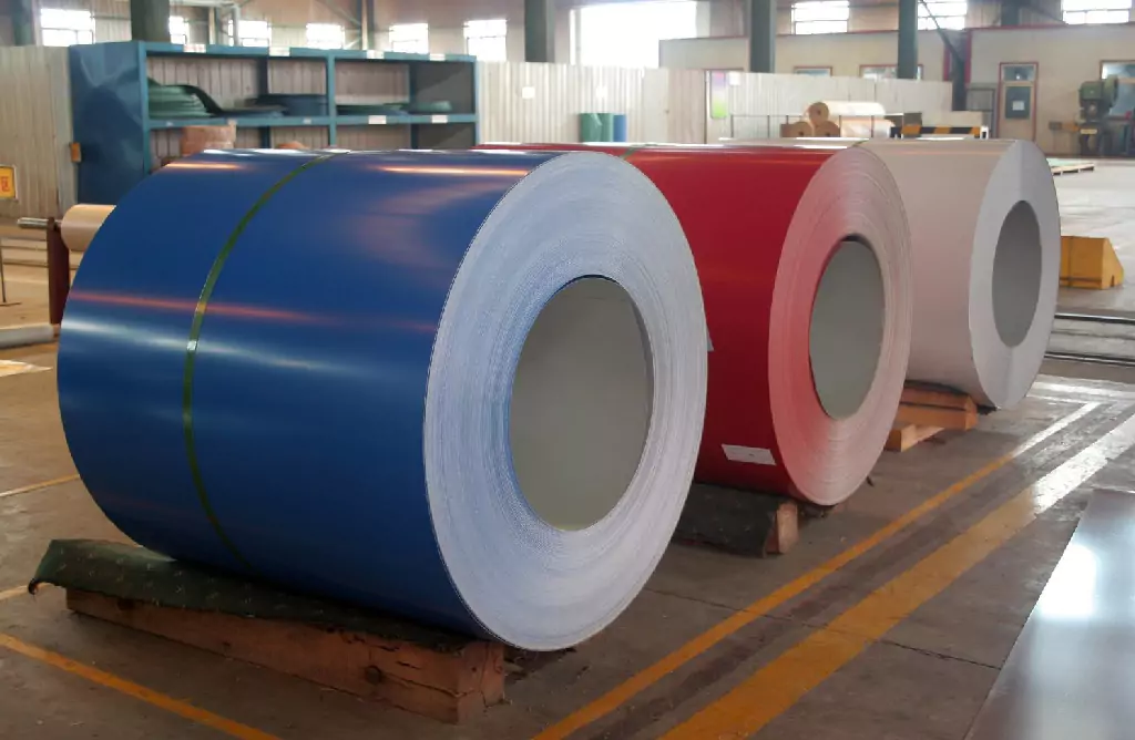 Coiled Metal Rolls, Blue, Red, and Silver, in a Workshop
